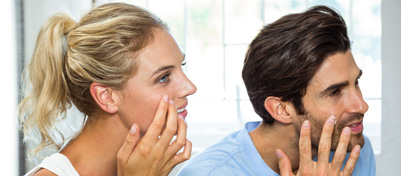 Man and Woman Applying Moisturizer on Their Face