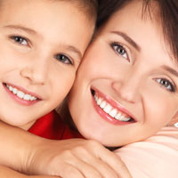 Child Dentist Chicago - Happy young mother with son