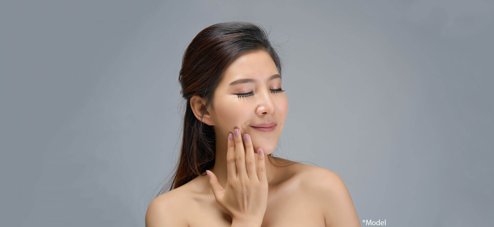 Happy beautiful asian girl with the fresh skin in dark background