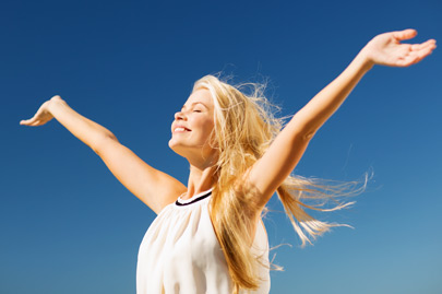 Beautiful happy woman enjoying summer outdoors