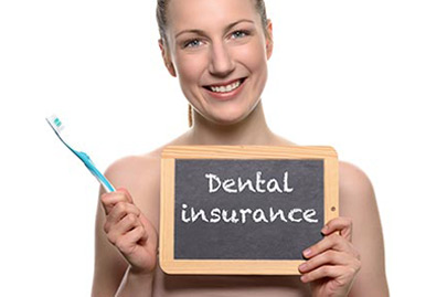 Beautiful woman holding dental insurance sign
