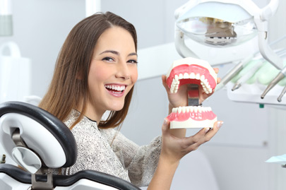 Dentist patient smiling with a plastic denture