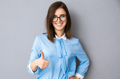Happy businesswoman showing thumb up