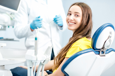 Happy female patient at the dental office