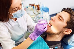 Man at the dentist's chair during a dental procedure Man at the dentist's chair during a dental procedure