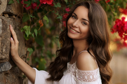 Pretty happy smiling girl with dark curly hair