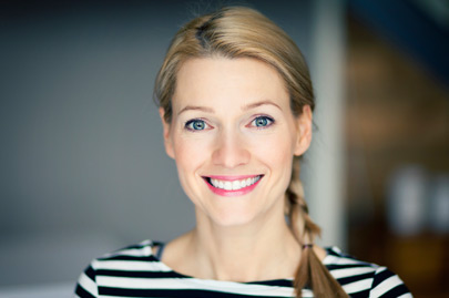 Smiling blond woman wearing a striped shirt