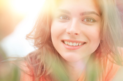 Smiling woman face on blurred background