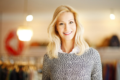 Woman standing in her clothing shop
