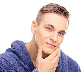 Young man touching his face