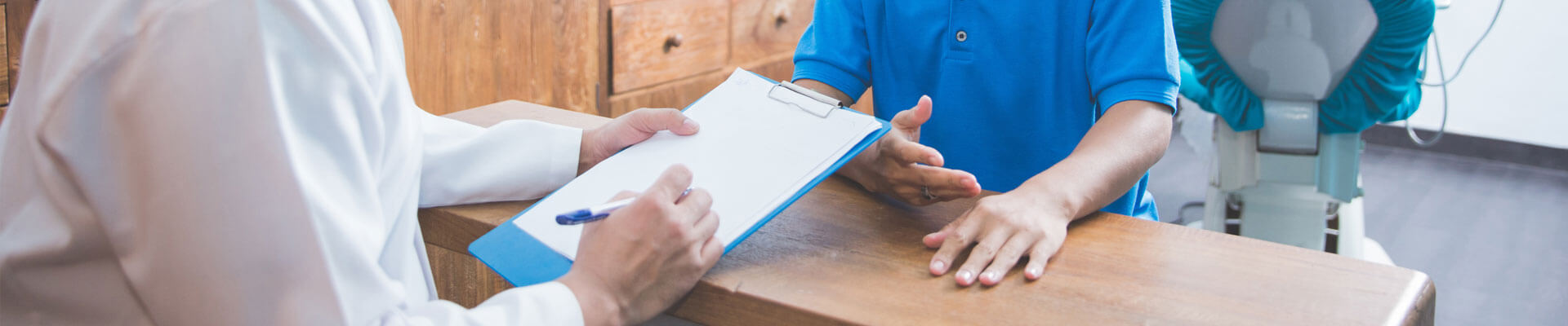 Cropped image of dentist and patient discussing at dental office