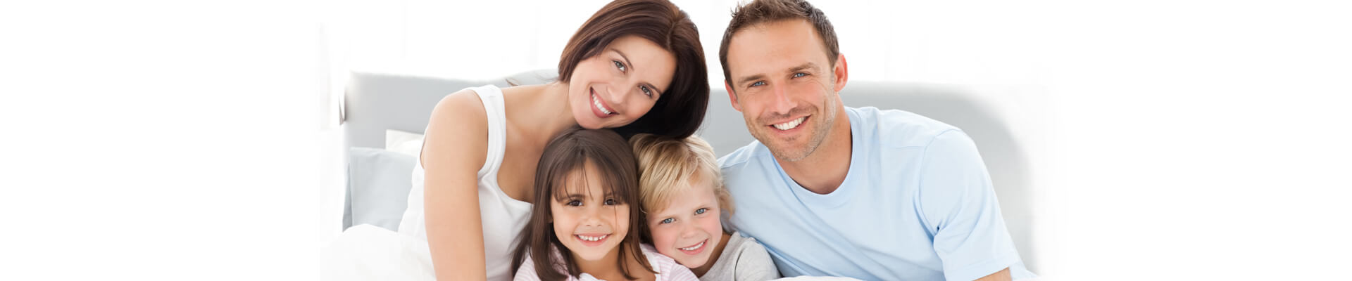Happy family smiling on bed