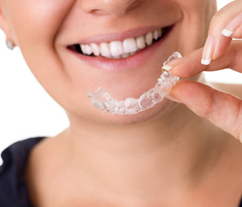 Woman Holding a Invisalign Brace