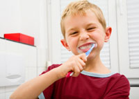 Children's Dental Treatment in Mississauga - Boy brushing his teeth in bathroom