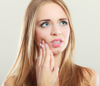Woman suffering from tooth pain