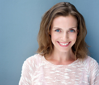 Smiling woman in blue background