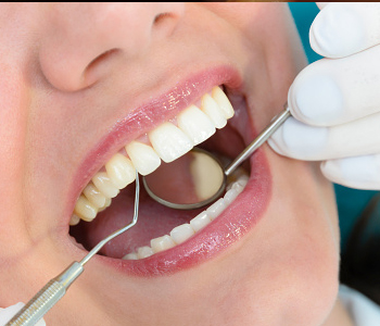 A Dentist checking patient teeth