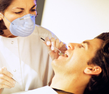 Dentist examining patient