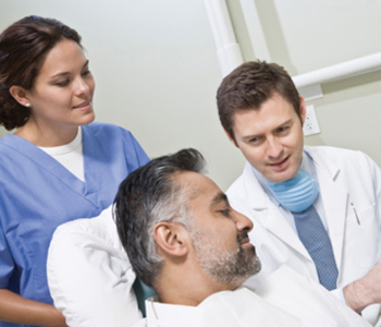 Dentist and patient looking at x-ray