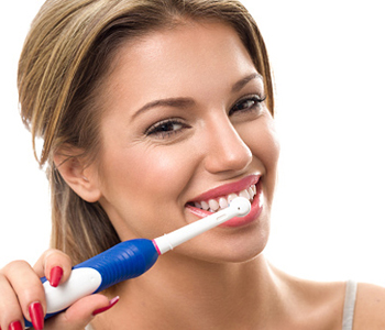 Young beautiful woman brushing her healthy teeth