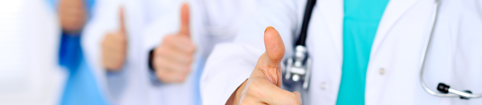 Group of doctors showing sign with thumb up