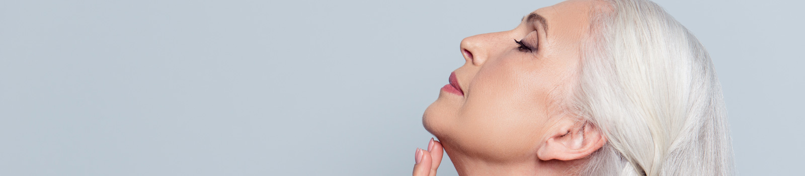a women touching her skin of neck with hand