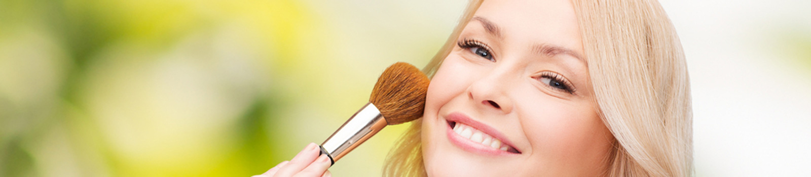 Beautiful woman with closed eyes and makeup brush