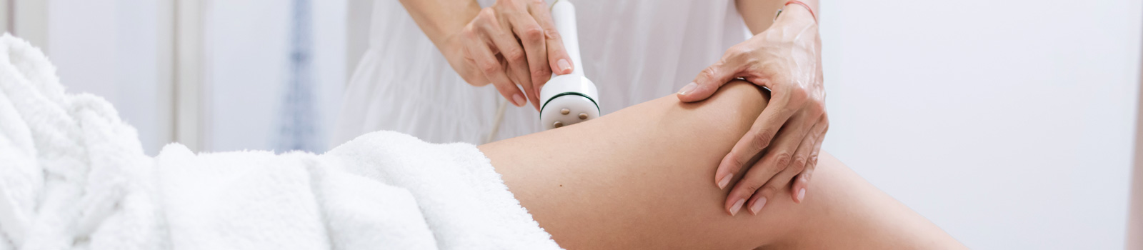Young woman having radio frequency lifting legs treatment