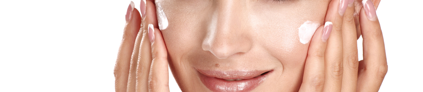Beautiful model applying cosmetic cream treatment on her face