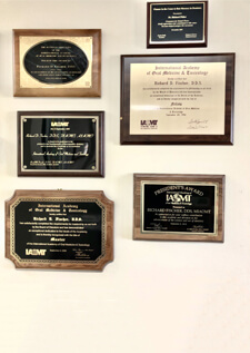 Multiple awards hanged on wall