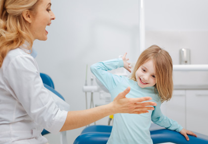 Active energetic child happy with her dentist