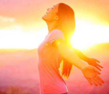 Free happy woman enjoying nature sunset