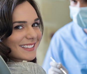 woman at the dentist relaxed and smiling