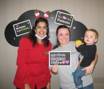 Mother holding Infant after Oral Exam by Sona J. Isharani, DDS in greensboro nc
